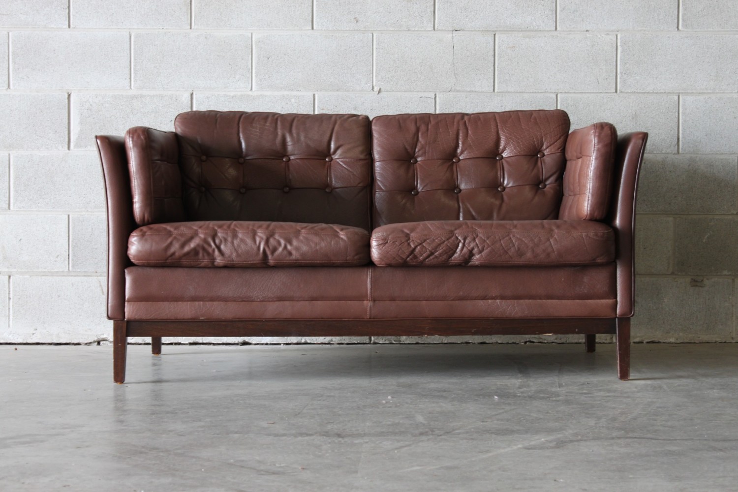 Pair of brown button backed sofas